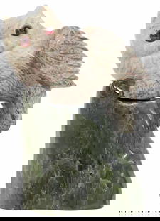 GEMSTONE RHODONITE & NEPHRITE CARVING OF AN OWL: Lapidary model of a long-eared owl, carved from rhodonite, with inset cabochon eyes, perched on a nephrite base, apparently unmarked, approx 4.5"h, 3.25"w, 2"d, 554 grams (inclusive of all materials)