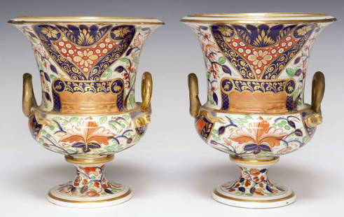 (2) ENGLISH ROYAL CROWN DERBY IMARI PALETTE CAMPANA URNS / VASES: (pair) English Imari palette bone china vases/ urns, Royal Crown Derby, early 19th c., each having campana-form body with dual looped handles, decorated with Japanese style foliates and floral motifs