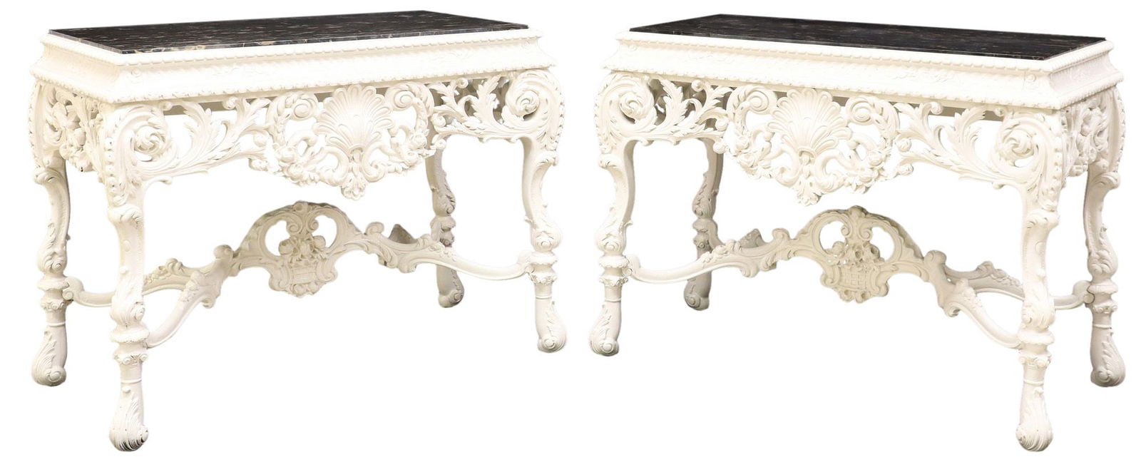 (2) GEORGE II STYLE MARBLE-TOP WHITE-PAINTED CONSOLE TABLES: (pair) George II style white-painted console tables, 20th c., each having inset rectangular marble top, pierced apron with fanned shell motif, among flowers and scrolling foliates, rising on stretcher
