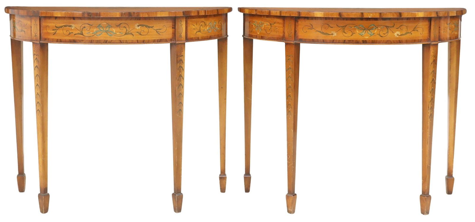 (2) ADAMS STYLE PAINTED MAHOGANY DEMILUNE CONSOLE TABLES: (pair) Adams style paint-decorated mahogany console tables, 20th c., each having demilune top with crossed arrows and ribbon motif, among Neoclassical foliate scrollwork, rising on tapering squared le