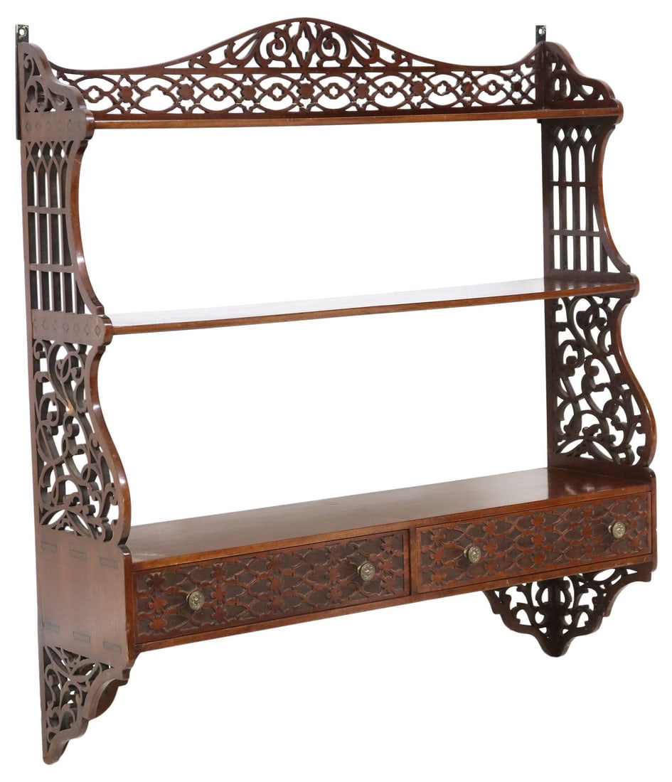 GEORGE III CHIPPENDALE MAHOGANY FRETWORK HANGING SHELVES: English George III mahogany hanging shelves, in the manner of Thomas Chippendale (British, 1718-1779), early 19th c., three open shelves above two small drawers, pierced fretwork sides, typical restor