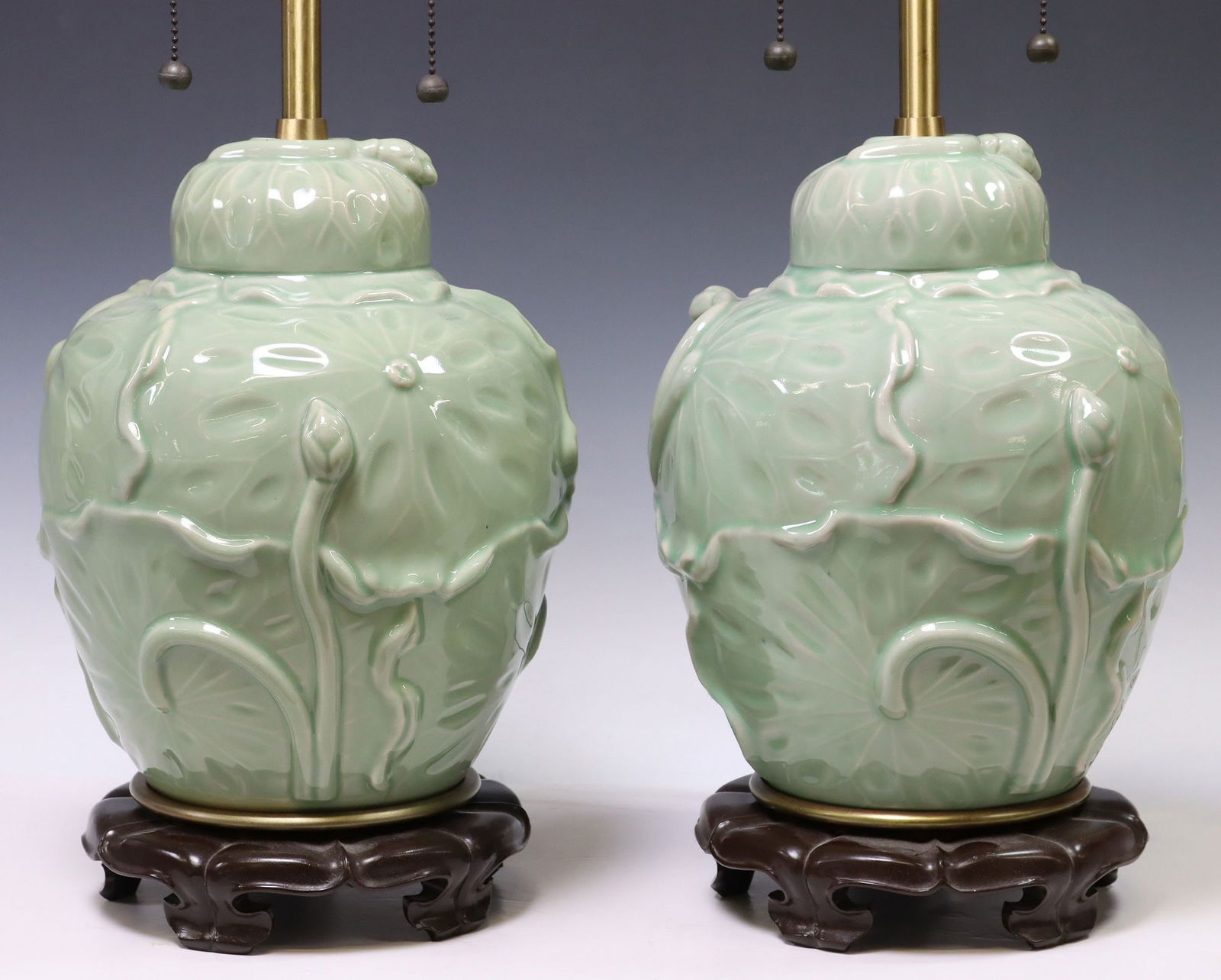 (2) MARBRO CHINESE STYLE CELADON PORCELAIN VASIFORM 2-LT TABLE LAMPS: (pair) Chinese style celadon-glazed porcelain two-light table lamps, Marbro Lamp Company, 20th c., each standard in the form of a covered jar, with relief-molded cabbage leaf motifs, on integral pierc