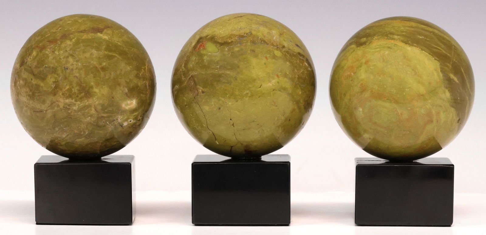 (3) GEOLOGICAL GREEN MARBLE SPHERES ON BLACK MARBLE BASES (1 of 3)