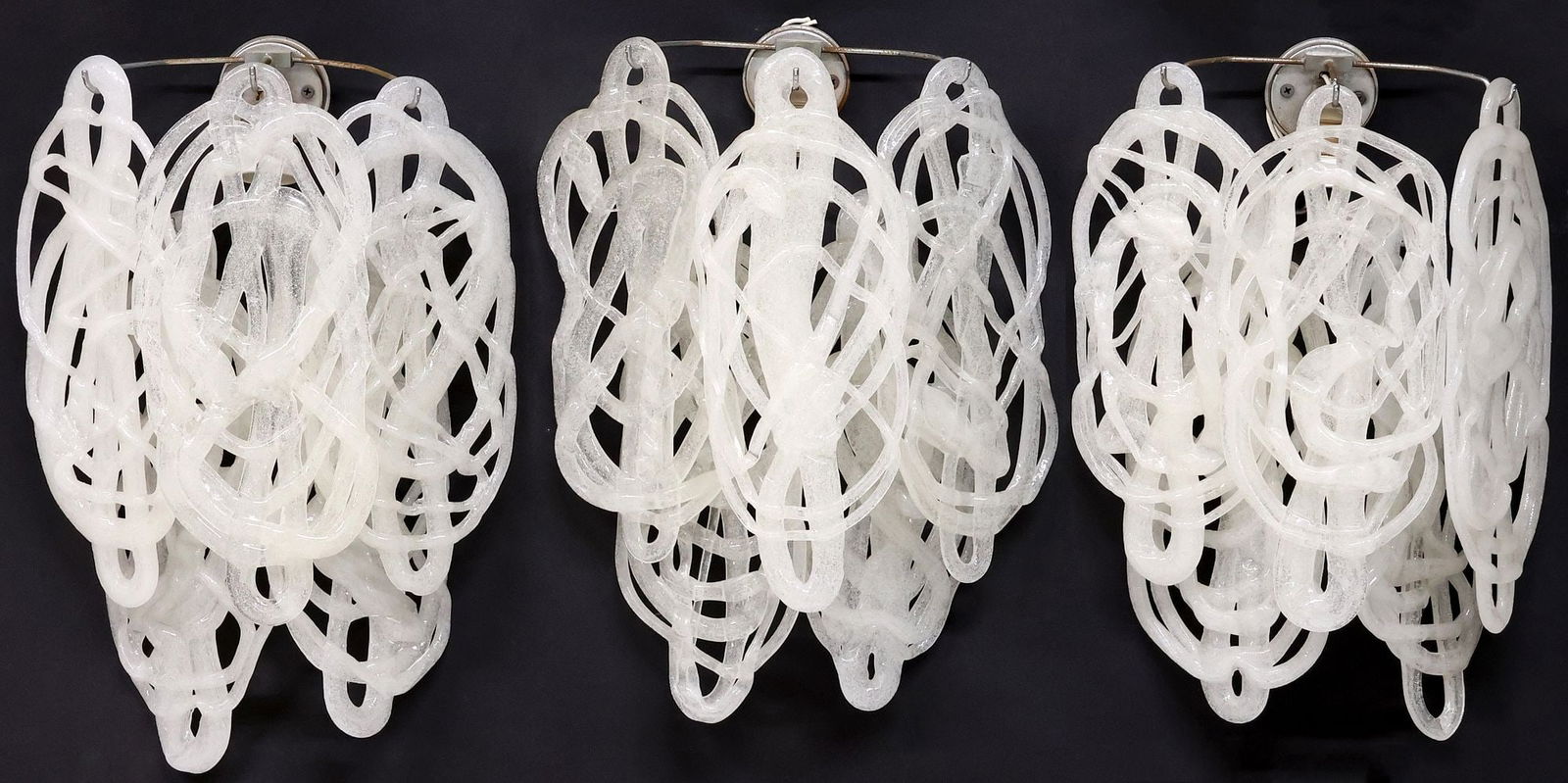 (3) MAZZEGA (ATTRIB.) MURANO ART GLASS 'RAGNATELA' 1-LT WALL SCONCES: (lot of 3) Italian Modern Murano art glass wall sconces, attributed to Mazzega, c.1970s, in the "Ragnatela" or spiderweb design, each issuing single light, flanked by five hooked metal arms, all suppo