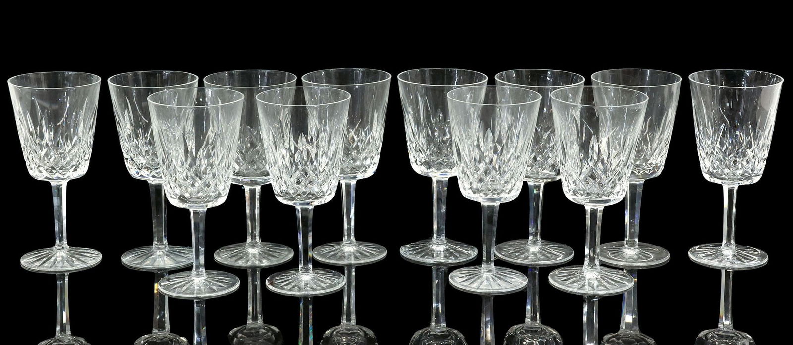 (12) WATERFORD 'LISMORE' CUT CRYSTAL WATER GOBLETS: (lot of 12) Waterford cut crystal water goblets, in the "Lismore" pattern, bowl with vertical cuts, multi-sided stem, each with acid-etched mark underfoot, (one) with minute rim chip, approx 6 7/8"h,