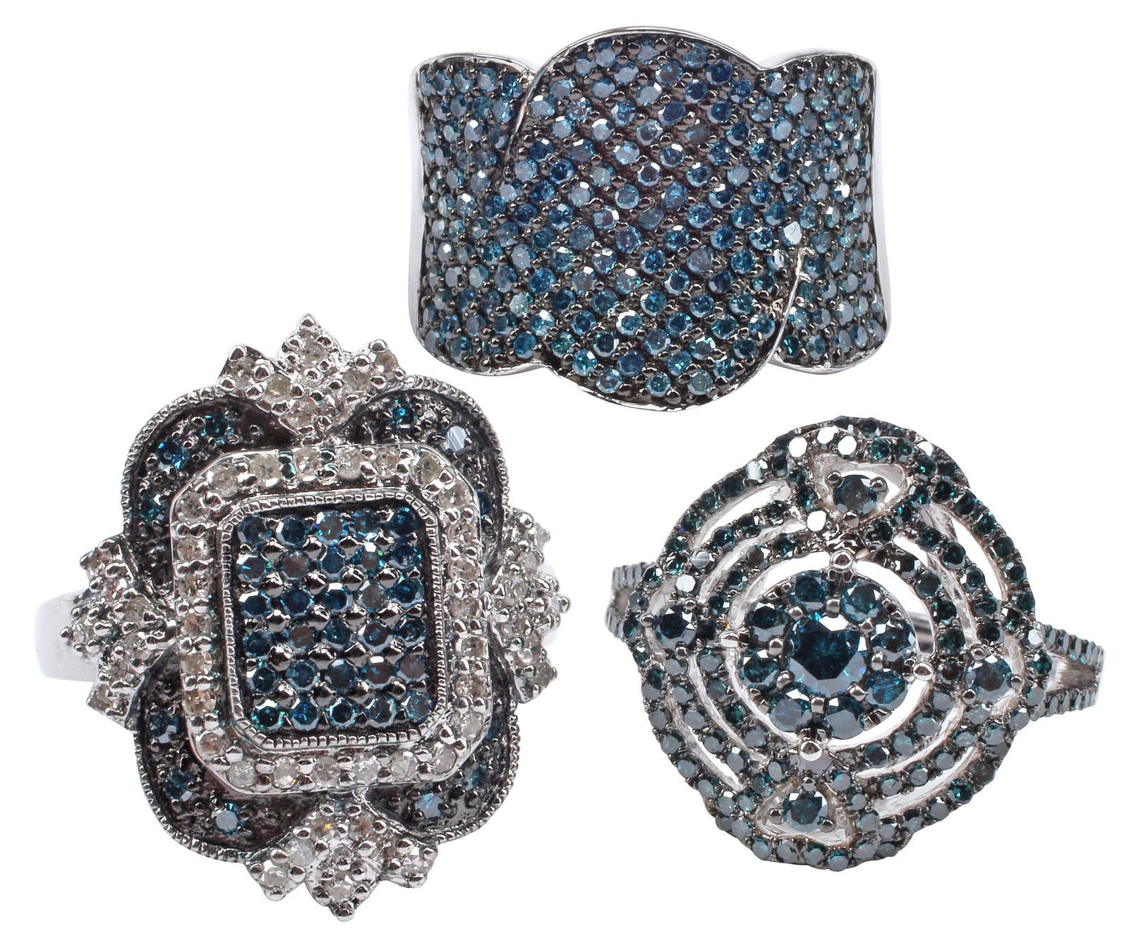 (3) ESTATE STERLING SILVER & TREATED BLUE DIAMOND COCKTAIL RINGS: (lot of 3) Estate sterling silver and color-treated blue diamond cocktail rings, all approx size 7, including: (1) having rectangular plaque with protruding fan motifs, (1) scalloped band set with num