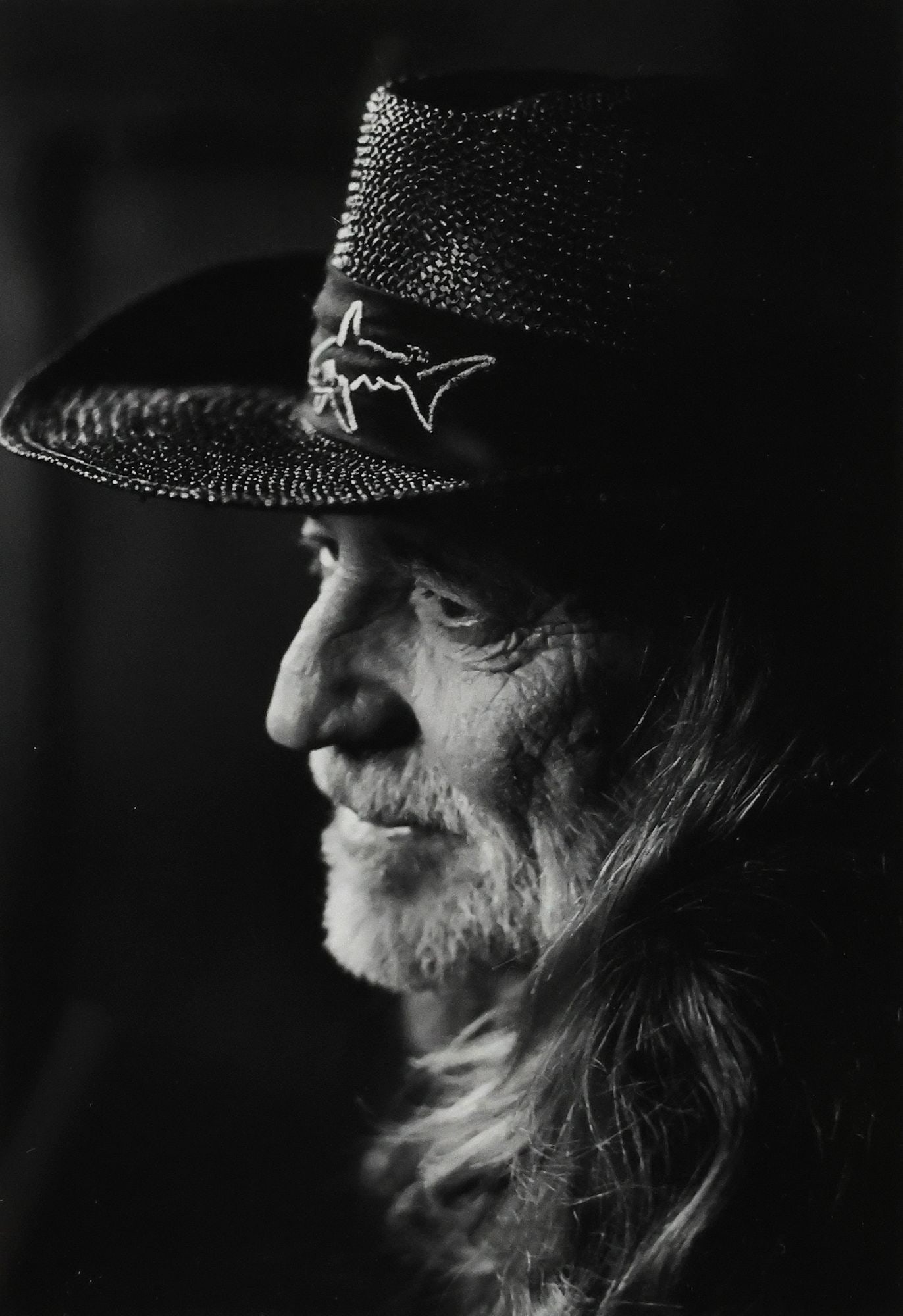 DICK WATERMAN (1935-2024) GELATIN SILVER PRINT OF WILLIE NELSON 1993: Framed gelatin silver print on paper, Willie Nelson at Austin City Limits Studio, pencil signed on the mat lower right Dick Waterman (American, 1935-2024), dated 1993, accompanied by certificate of au