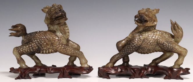 (2) CHINESE CARVED HARDSTONE MYTHICAL QILIN ON WOOD STANDS
