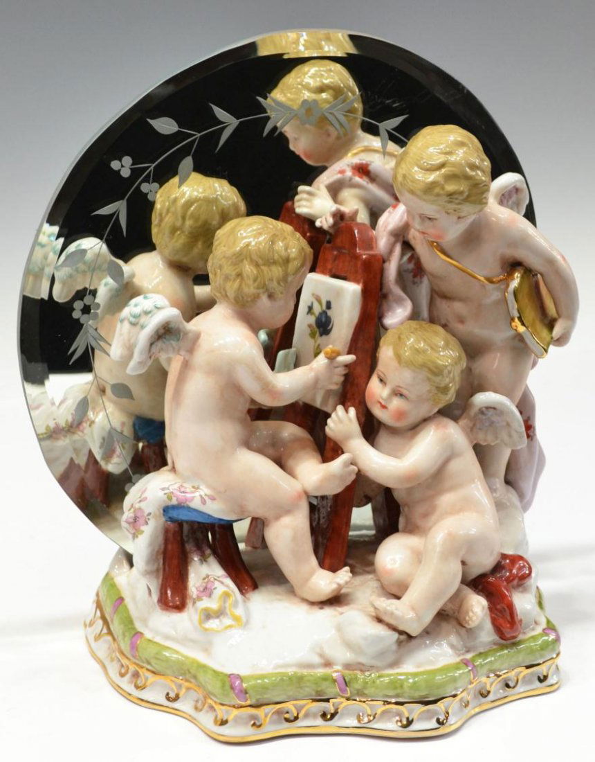 MEISSEN STYLE POLYCHROME NUDE PUTTI FIGURAL GROUP: Meissen style polychrome porcelain figural group, three nude winged putti in an artists setting, set in front of a beveled floral etched mirror, marked as pictured, overall: 9.25"h, 8"w, 5"d, 4.25lbs