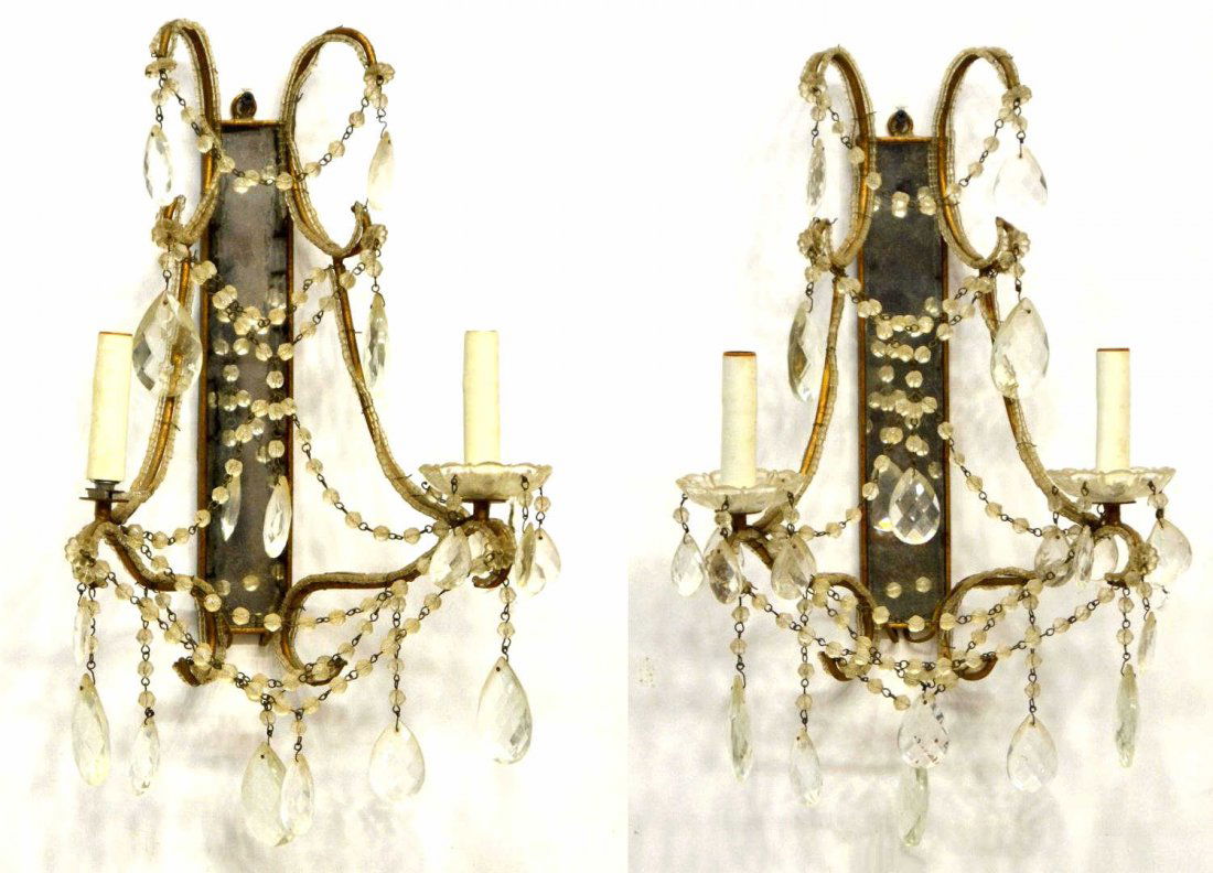 PAIR CONTINENTAL PRISM MIRRORED WALL SCONCES: (pair) Vintage two-light wall sconces, the gilt metal and beaded frame having scrolled arms terminating in colorless bobeche, the whole hung with prisms and swags, centering a long rectangular mirror,