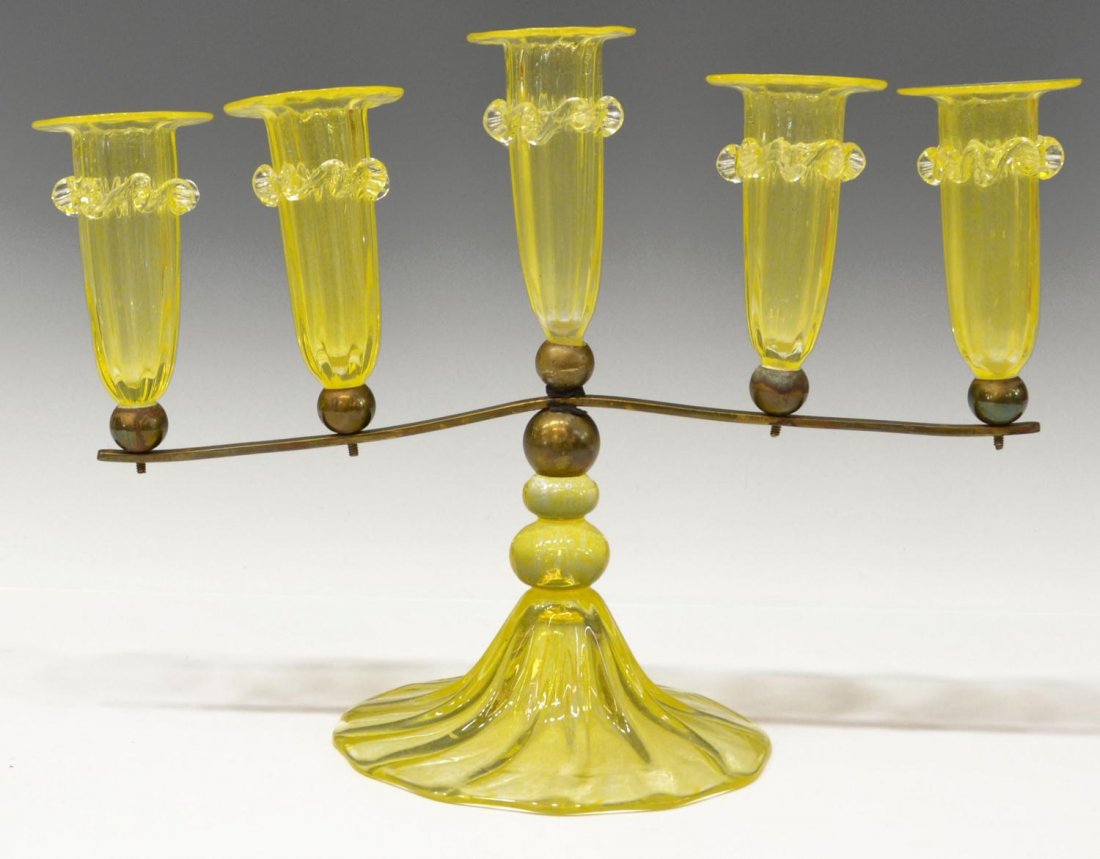 FIVE FLUTE ART GLASS PEDESTAL EPERGNE: Art glass epergne with rigaree swags, five flutes resting on metal outstretched arm, conforming yellow glass base, restoration to central standard, one flute with minor chip at rim, 9"h, 11.75"w, 2lbs