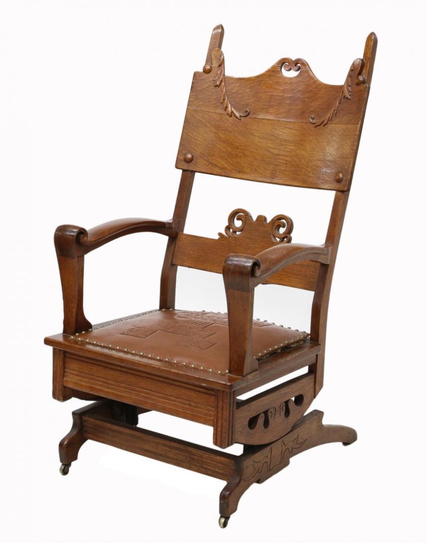 AMERICAN ARTS & CRAFTS OAK PLATFORM ROCKER: American Arts & Crafts oak rocking chair, c. 1915, laminated pierced wide top rail and conforming cross rail, the leather seat flanked by shaped arms terminating in an upward scroll, rising on two par