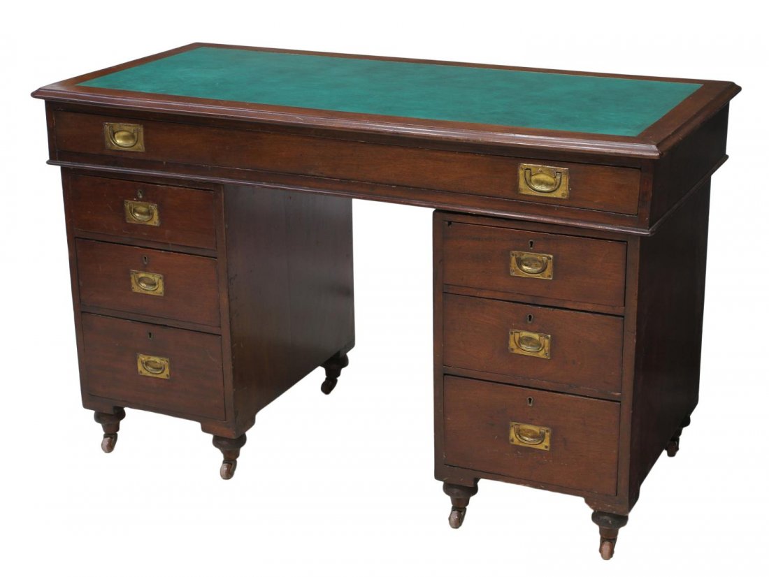 BRITISH COLONIAL TEAKWOOD CAMPAIGN DESK: British Colonial teakwood campaign desk, early 20th c., the rectangular top with later inset writing surface having a long frieze drawer, two three drawer pedestals with inset brass pulls, retaining s