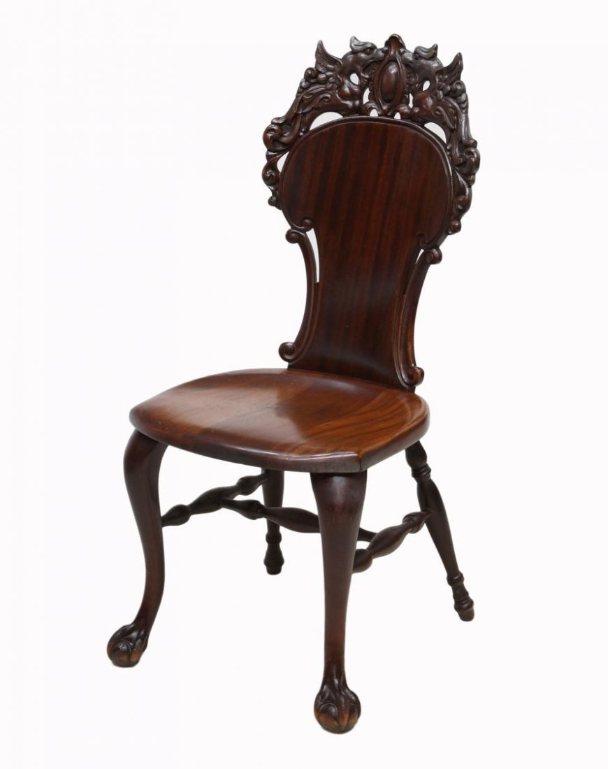 STICKLEY & BRANDT CARVED MAHOGANY CHAIR: American carved mahogany side chair c. 1910, a central shield panel crest held by flanking winged griffins over the shaped back, a contoured mahogany seat on cabriole front legs with ball and claw fee