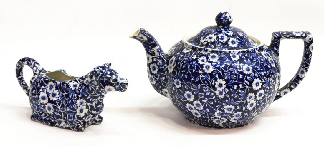 STAFFORDSHIRE PORCELAIN CALICO TEAPOT & CREAMER: (lot of 2) English Burleigh, Staffordshire, porcelain tea items, in the 'Calico' pattern, cobalt blue with white blooming branches, comprising: (1) loose tea Ironstone teapot, 5.75"h, 9.5"w; (1) cream
