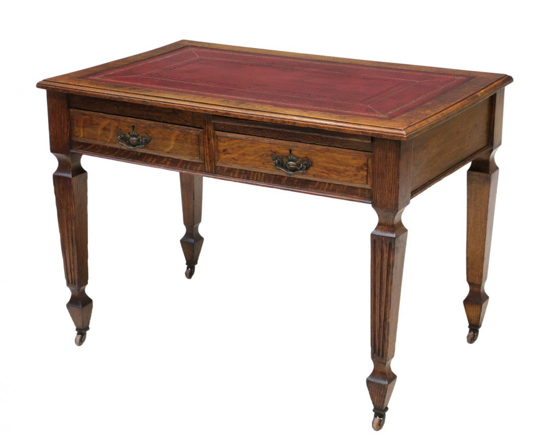 BRITISH OAK LIBRARY TABLE OR DESK, 19TH C.: English oak library table or desk, 19th c., the rectangular top with inset leather writing surface over a pull out tray and two frieze drawers, all rising on tapered square legs with spade feet on por