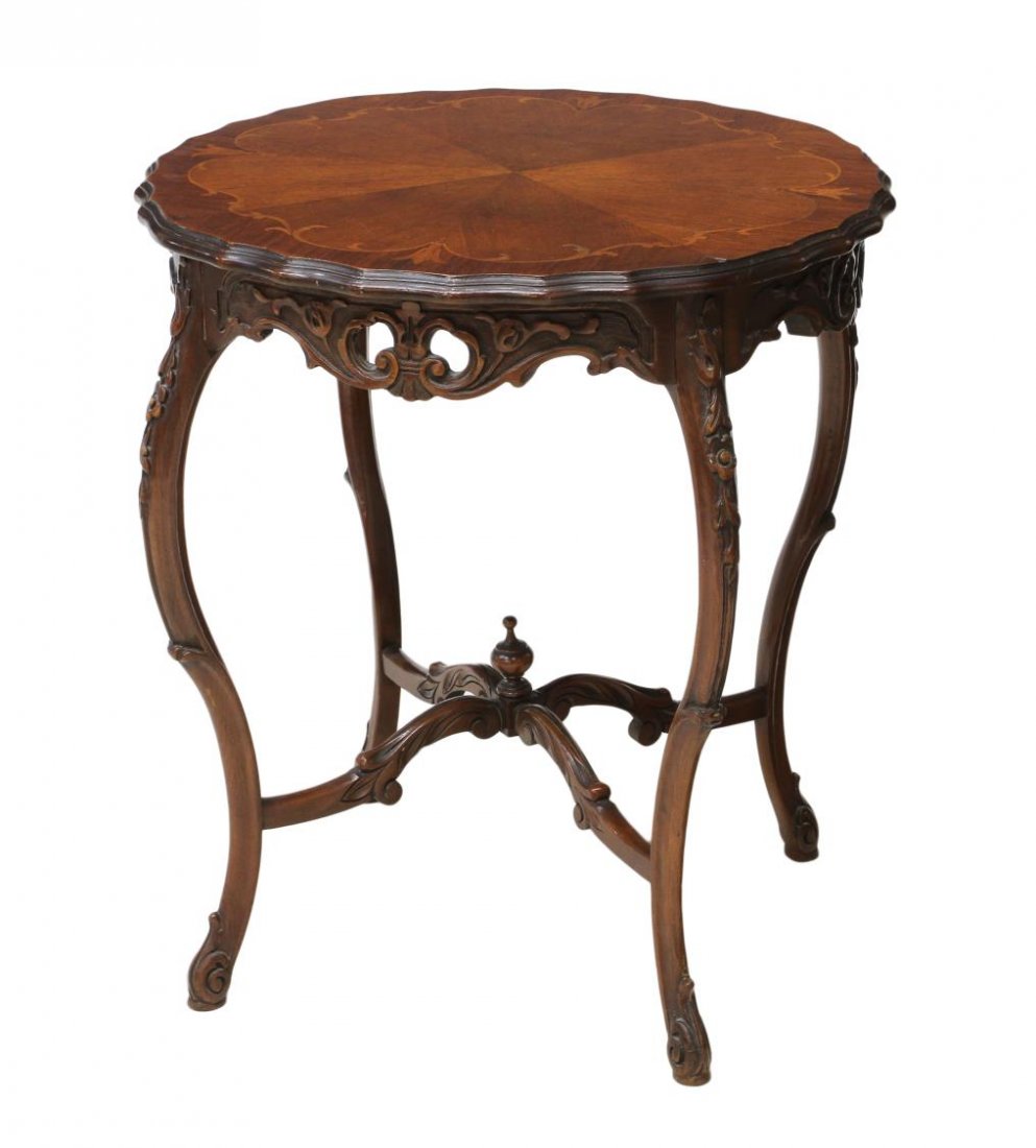 AMERICAN ROUND TOP MARQUETRY INLAID LAMP TABLE: American lamp table, 1930's, a circular top with pie crust edge and marquetry inlay over foliate pierce carved frieze, rising on stretcher joined cabriole legs with central finial, and scrolled feet,