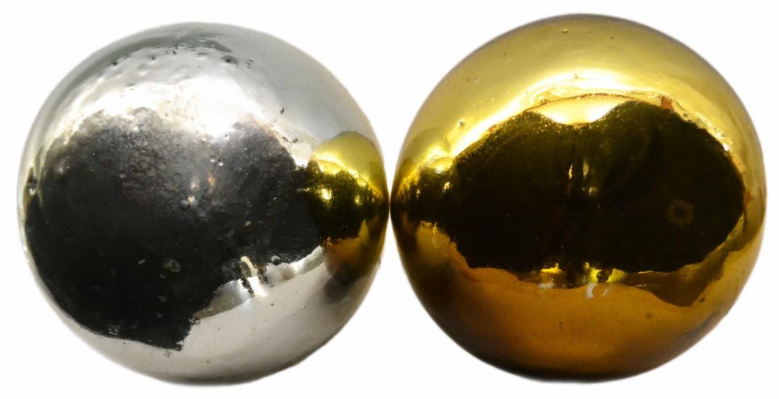 (2) LARGE VICTORIAN GAZING BALLS, YELLOW & SILVER: (lot of 2) Large Victorian glass gazing globes, in the colors of yellow and silver, glue residue, some wear and loss to finish with age, largest: approx. 11"diam, 12lbs Start Price: $50.00