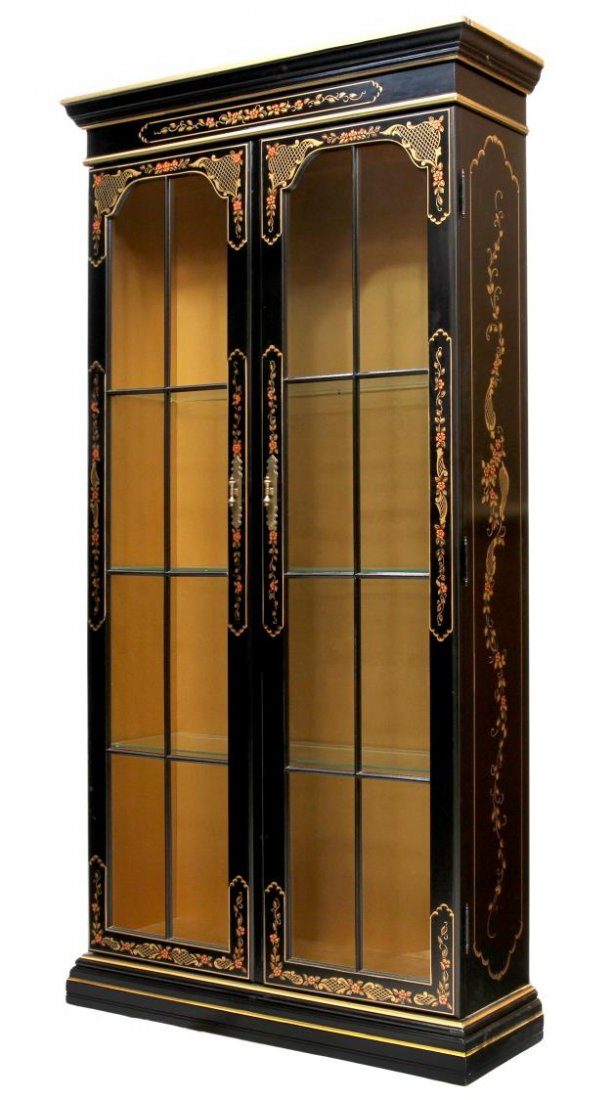 CHINESE STYLE DOUBLE GLASS DOOR DISPLAY CABINET: Chinese style black display cabinet, late 20th c., foliate and gilt decoration with a stepped cornice over two long glass paneled doors opening to the lighted interior with glass shelves, all rising o