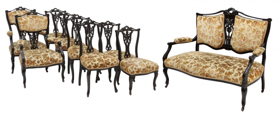(9) VICTORIAN CARVED ROSEWOOD PARLOR SUITE: (lot of 9) American Victorian rosewood parlor suite, c. 1890, the pierce carved frame each with foliate detail, floral and foliate brocade upholstery: (1) two seat settee, padded arms, rising on casto