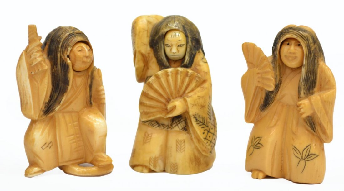 (3) JAPANESE CARVED IVORY FIGURAL NETSUKES: **International Shipping Is Not Available On This Lot** (lot of 3) Collection of Japanese carved netsukes of figures with rotating heads with two different faces, dark colored accents and incised flor