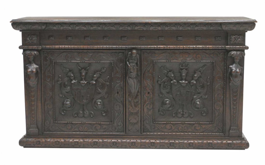 19TH C RELIEF CARVED OAK SIDEBOARD,KNIGHT & SHIELD: Antique oak sideboard, 19th c., rectangular form with front figural mounted pilasters flanking two doors with shield and knight carving, a central partial figure with bowed head, rising on floral carv
