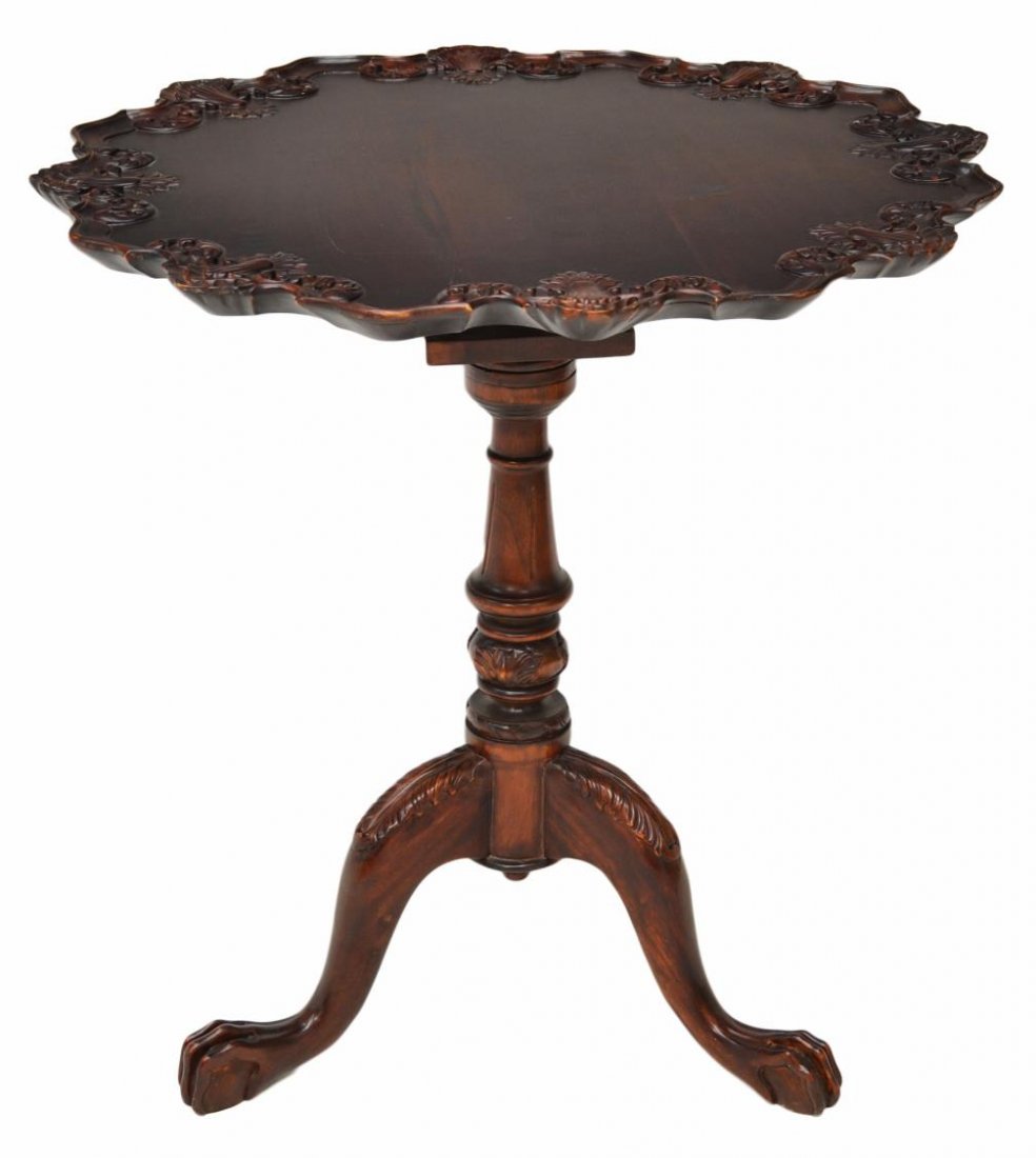 MAHOGANY TILT TOP OCCASIONAL TABLE: Mahogany tilt top occasional table, late 20th c., a pie crust edged top with shell carving rising on a central column with tripartite base, cabriole legs on claw feet, top vertical: 46.25"h, 29.5"w, 2
