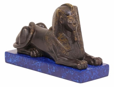 EGYPTIAN REVIVAL STYLE PATINATED BRONZE RECUMBENT SPHINX SCULPTURE