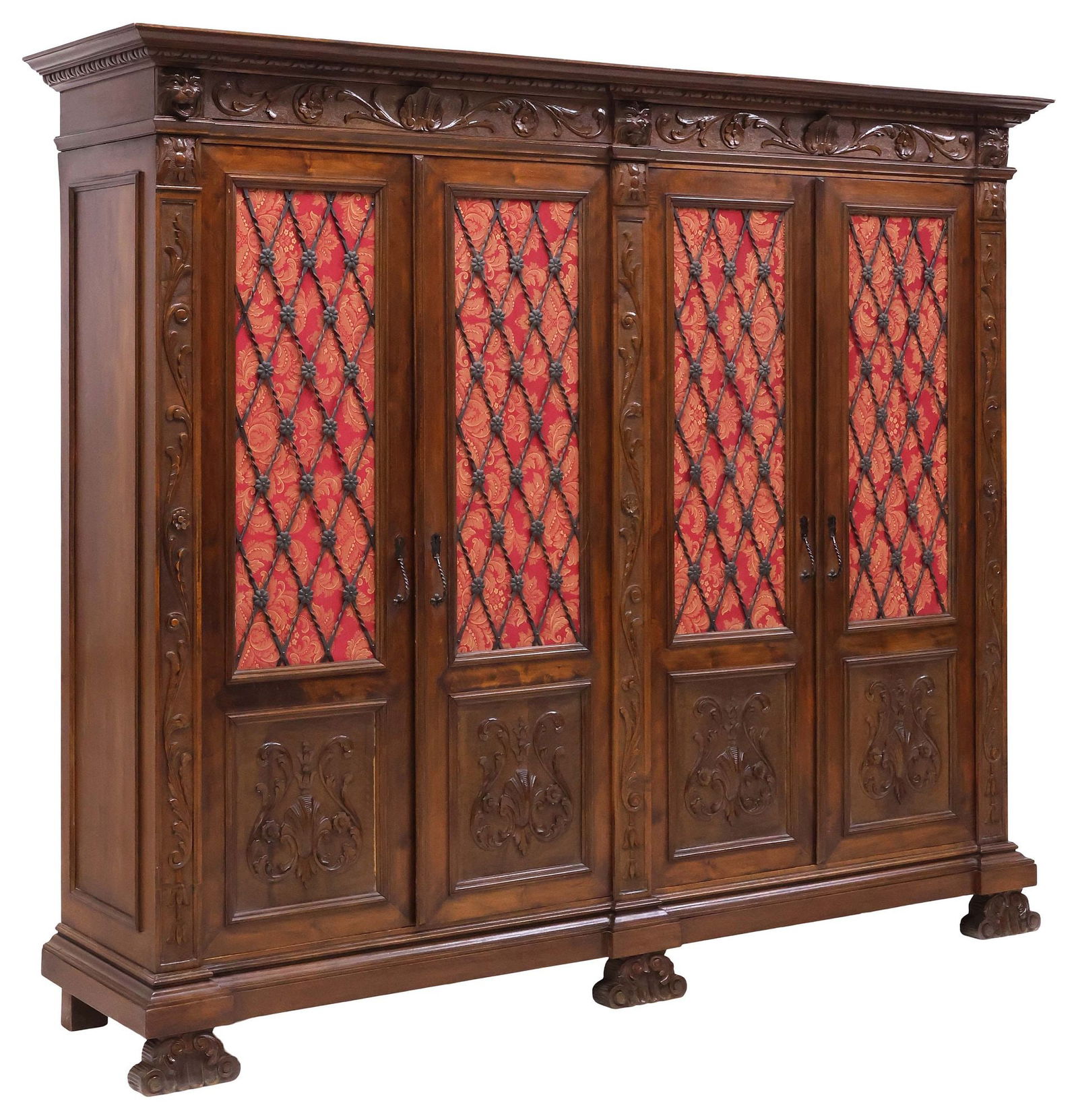ITALIAN RENAISSANCE REVIVAL WALNUT & WROUGHT IRON BOOKCASE: Italian Renaissance Revival carved walnut bookcase, late 19th c., having molded cornice, with scrolled foliate frieze and protruding lion masks, above four cabinet doors, with wrought iron latticing a