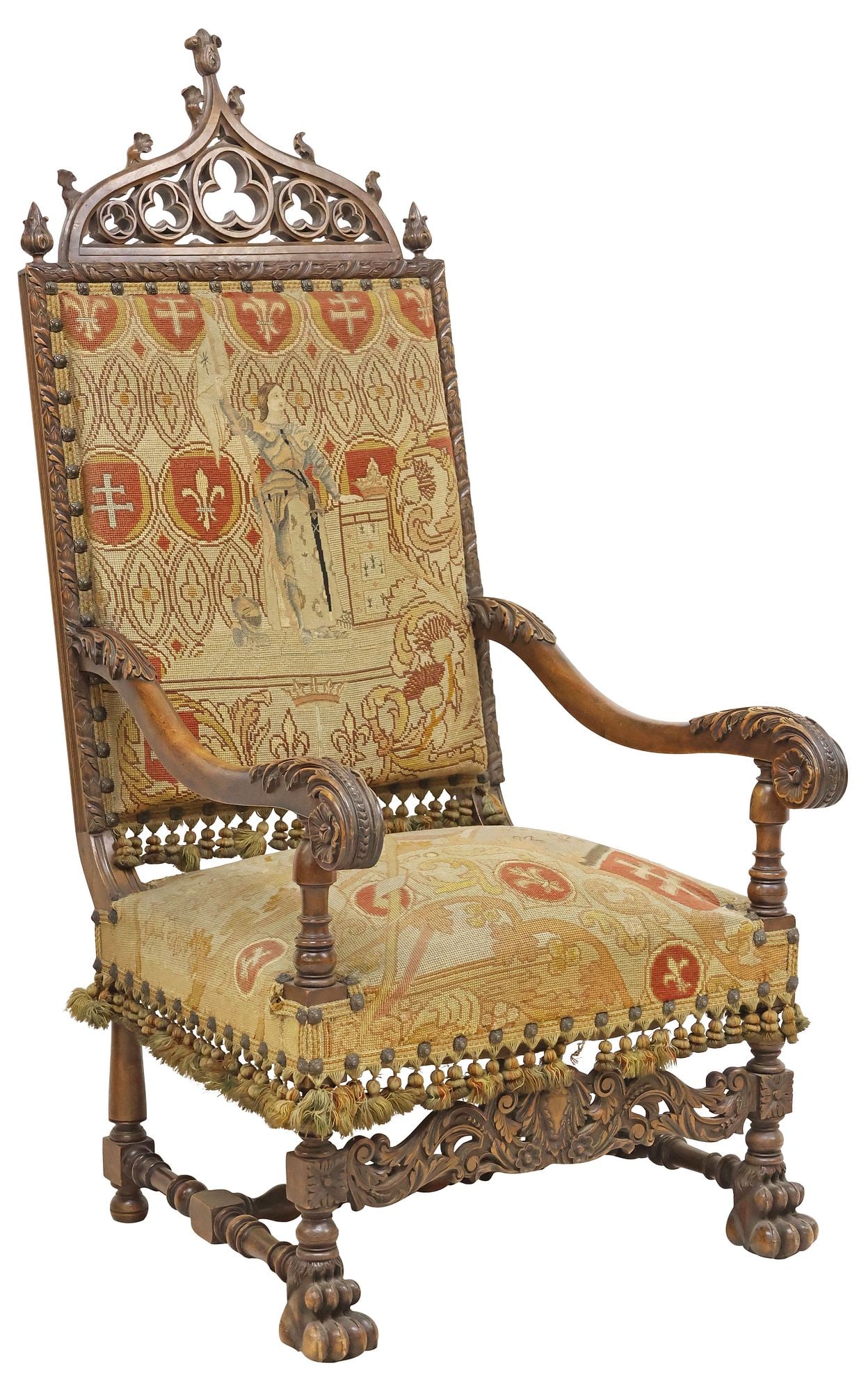 FRENCH GOTHIC REVIVAL JOAN OF ARC NEEDLEWORK UPHOLSTERED WALNUT ARMCHAIR: French Gothic Revival carved walnut throne chair, late 19th c., having pierced trefoil crest flanked by pointed finials, in fine petit-point and gros-point needlework upholstery, the back depicting Sa