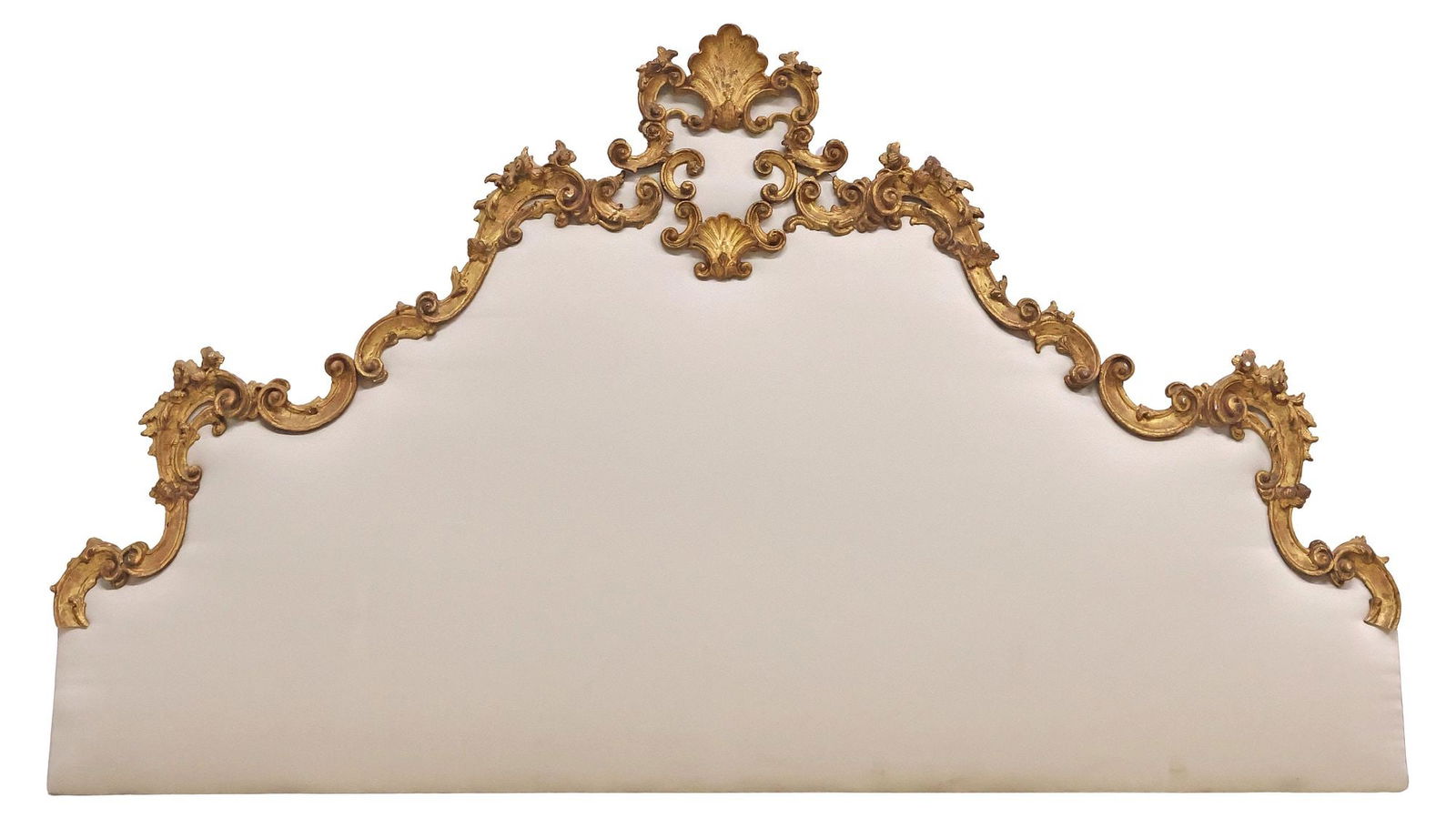 ITALIAN LOUIS XV STYLE UPHOLSTERED GILTWOOD HEADBOARD: Italian Louis XV style giltwood headboard, 19th c., gesso over wood, having shell crest, and openwork scrolling frame with floral and foliate motifs, padded board in a later-added light gray fabric up