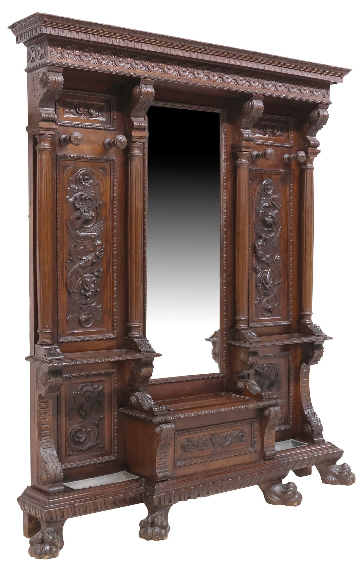 ITALIAN RENAISSANCE REVIVAL CARVED WALNUT MIRRORED HALL TREE: Italian Renaissance Revival carved walnut hall tree, early 20th c., having stepped cornice with floral roundels and beaded trim, above central beveled mirror plate, flanked by fluted columnar posts an