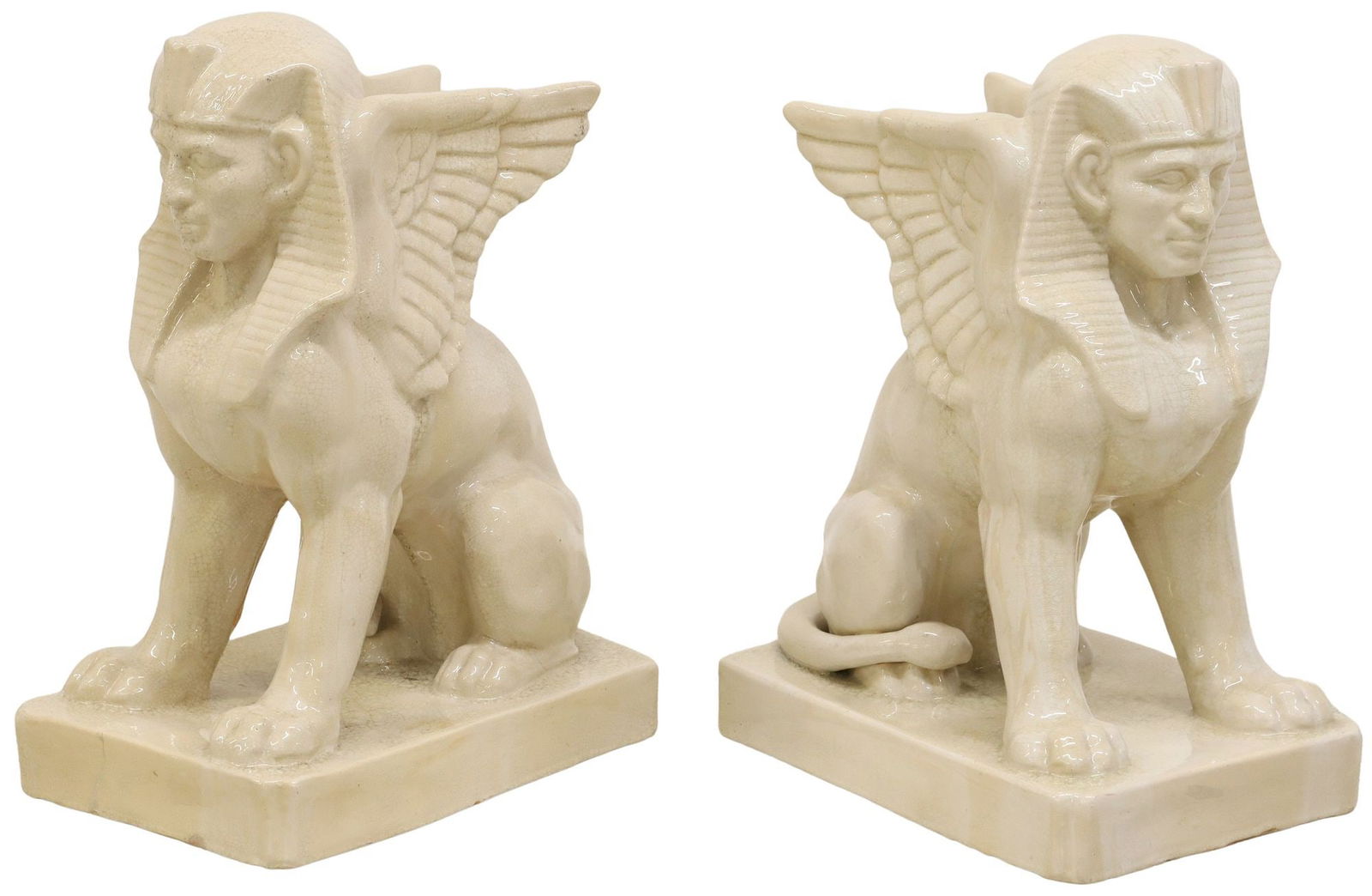(2) LARGE EGYPTIAN REVIVAL CERAMIC SPHINX SCULPTURES, 27"H: (pair) Large Egyptian Revival glazed ceramic sculptures, Winged Sphinx, each rising on integral canted rectangular platform, one intact with stable reinforced/filled hairline at front of base, some ch