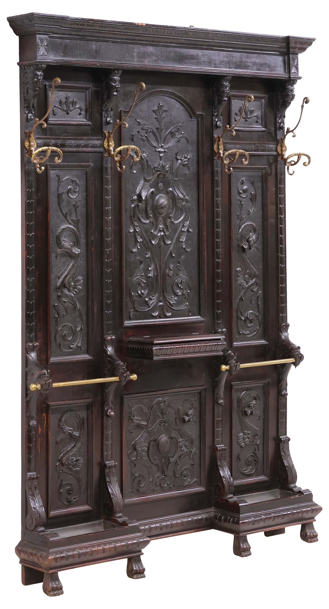ITALIAN RENAISSANCE REVIVAL CARVED WALNUT HALL TREE: Italian Renaissance Revival carved walnut hall tree, late 19th c., having stepped cornice, above four protruding lion masks issuing scrolled hat/ coat hooks, paneled back with central shield motif, am