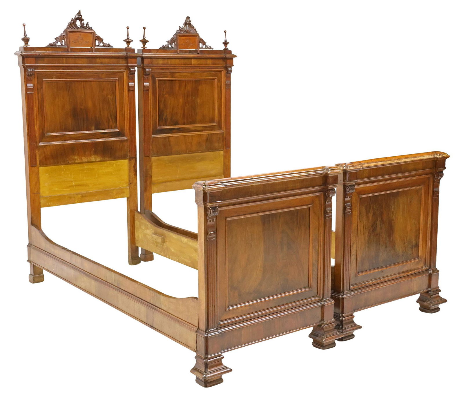 (2) ITALIAN CARVED WALNUT & MAHOGANY BEDS: (pair) Italian carved walnut and mahogany beds, 19th c., each having pierced triangular crest with incised scrollwork, flanked by turned finials, paneled head and foot boards with raised trim, framed