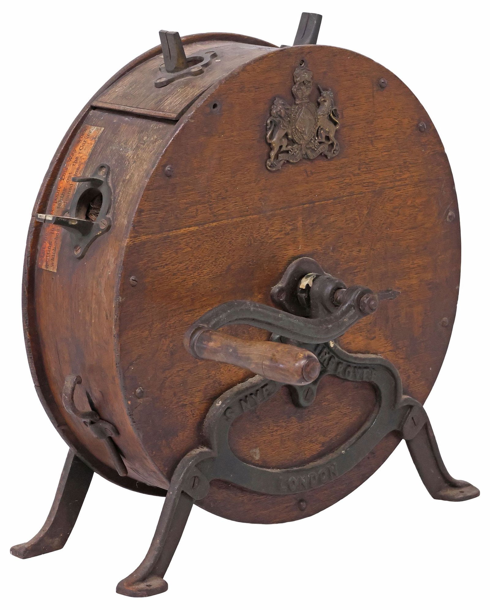 S. NYE & CO. OAK & CAST IRON ROTARY KNIFE SHARPENER: English oak and cast iron rotary knife sharpener, S. Nye & Company, London, early 20th c., mounted with patinated metal United Kingdom Royal coat of arms, equipped with hand-crank, rising on marked ca