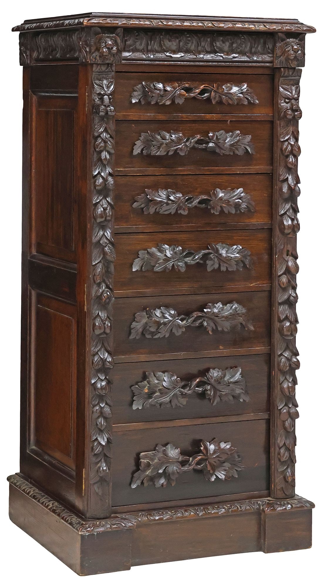 ENGLISH VICTORIAN OAK FOLIATE SIDE LOCK WELLINGTON CHEST: English Victorian oak side-locking Wellington chest, late 19th c., flat top over cornice with scrollwork and lion head motifs, paneled sides, having eight drawers with foliate carved handles, rising o