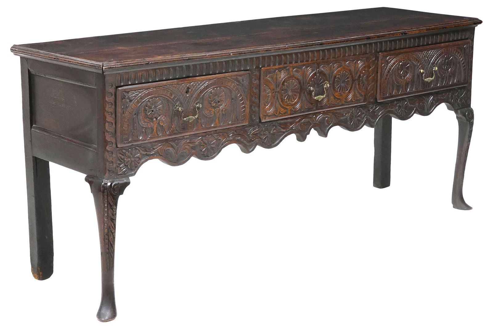 ENGLISH FLORAL & FOLIATE CARVED OAK DRESSER BASE, EARLY 19THC.: English kitchen dresser base, early 19th c., having rectangular top with molded edges, over three drawers, carved facade with arching floral medallion motif, above scrolling foliate apron, rising on f