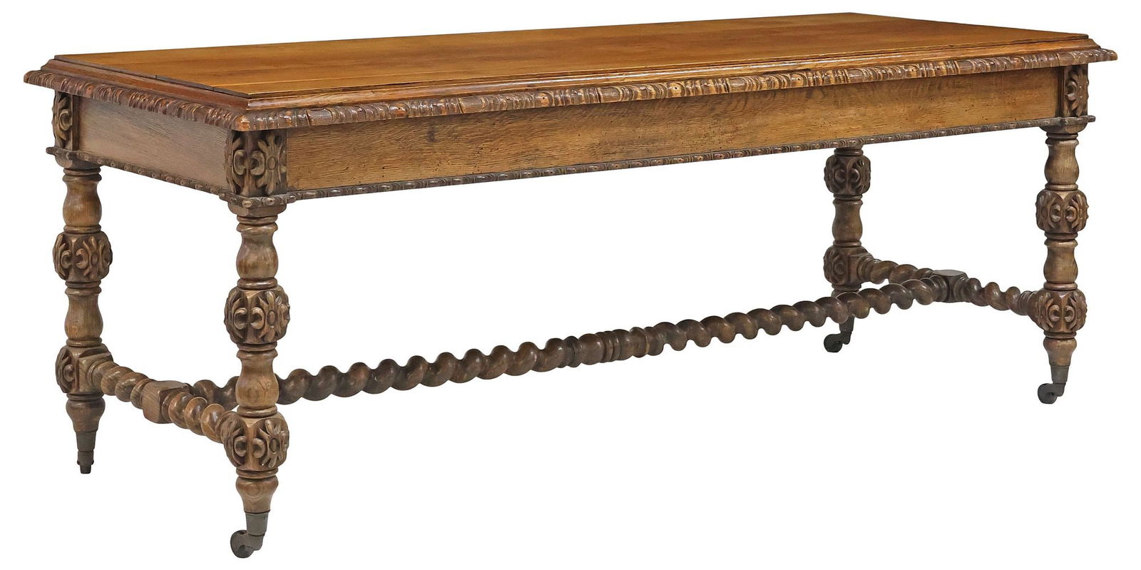 ENGLISH VICTORIAN CARVED OAK TABLE: English Victorian carved oak table, 19th c., having a stepped rectangular top, rising on turned supports with protruding carved florals, joined by barley twist H-stretcher, ending on casters, tabletop