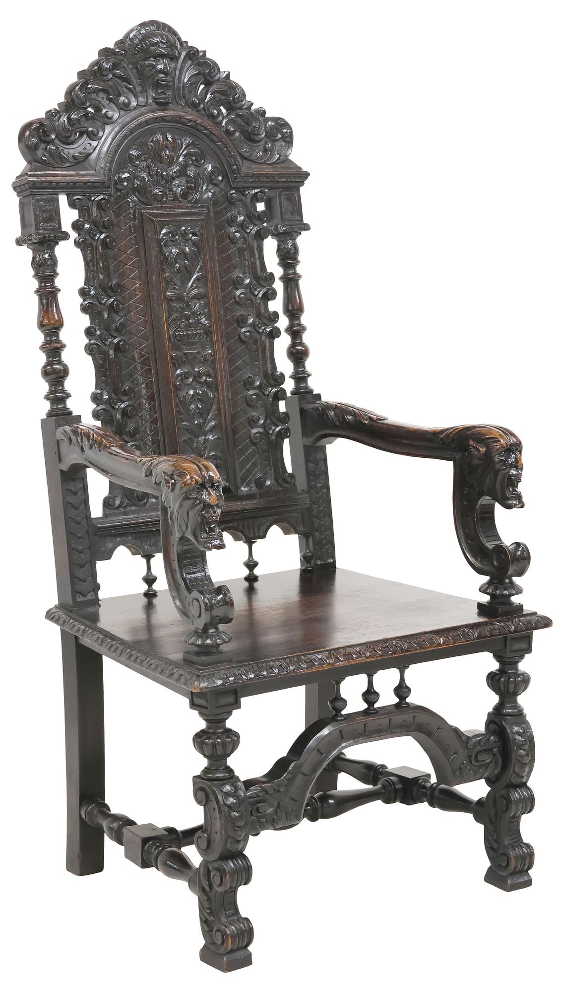 ENGLISH VICTORIAN HIGHLY CARVED OAK THRONE CHAIR: English Victorian carved oak high-back armchair, late 19th c., having scrolled crest with central grotesque mask, over heavily carved back with volute scrollwork and foliate motifs, arms terminating a