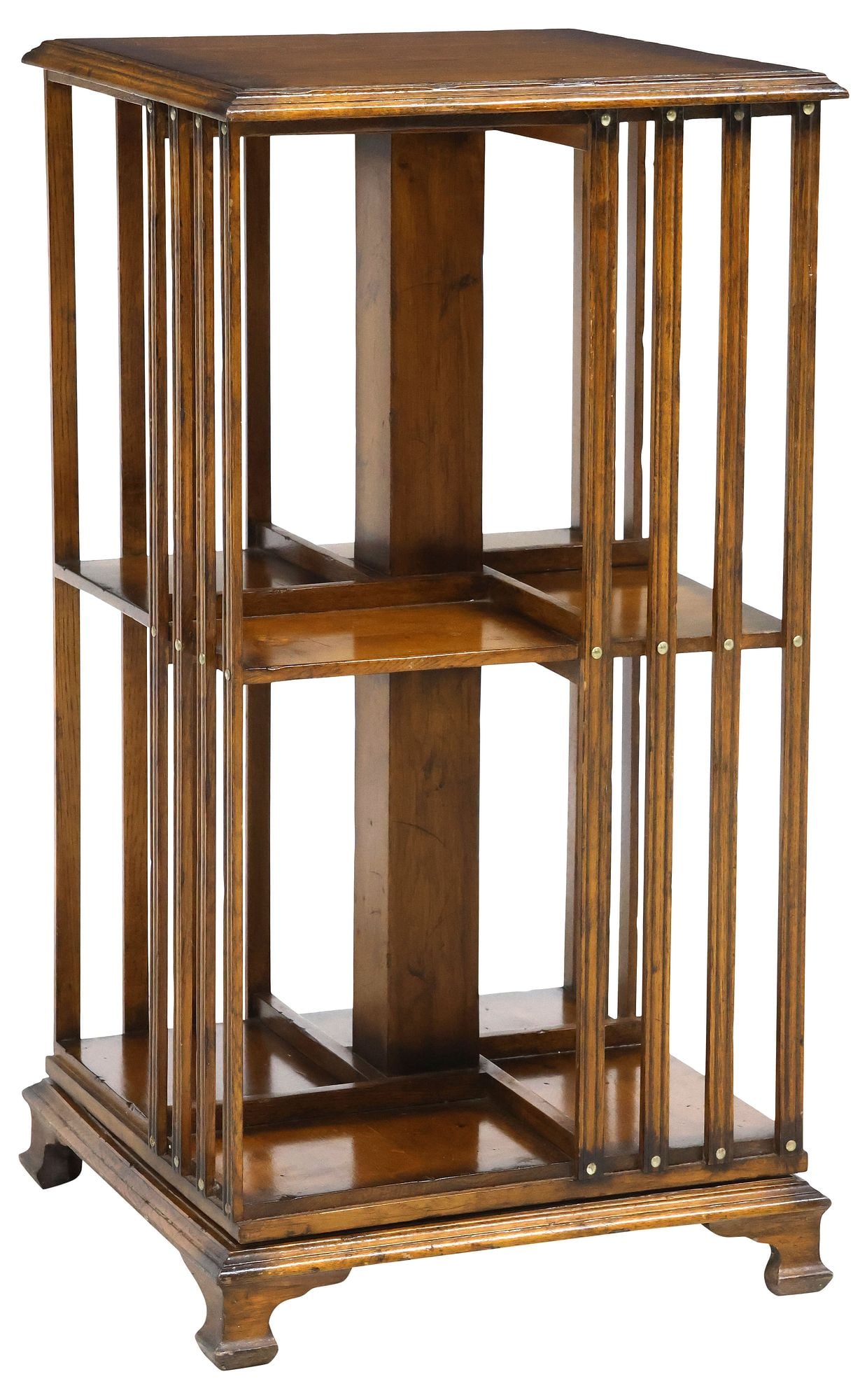 ENGLISH OAK ROTATING LIBRARY BOOKSTAND: English oak rotating library stand/ bookcase, 20th c., having molded cornice, over two tiers with reeded slatted sides, ending on squared bracket feet, approx 32.5"h, 17"w, 17"d