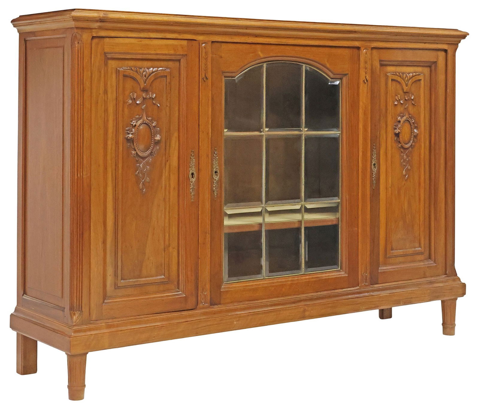 FRENCH LOUIS XVI STYLE WALNUT & LEADED GLASS SIDEBOARD / CABINET: French Louis XVI style carved walnut sideboard / cabinet, early 20th c., molded-edge rectangular case, with central cabinet encasing leaded and beveled glass panes, flanked by paneled cabinets at side
