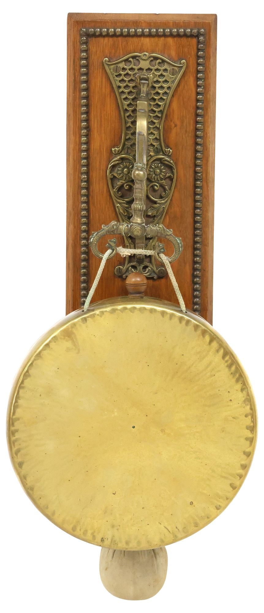 WILLIAM TONK & SONS EDWARDIAN OAK & BRASS DINNER GONG: English Edwardian brass dinner gong, William Tonks and Sons, early 20th c., oak wall plaque with nailhead trim, issuing openwork arm with foliated scrollwork and stylized dolphin motifs, suspending a