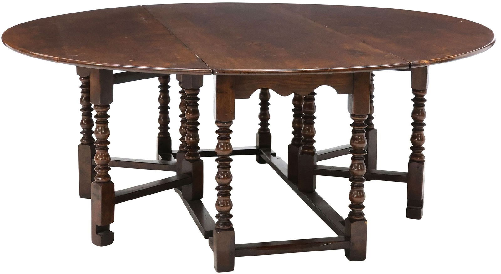 LARGE ENGLISH OAK DROP-LEAF WAKE TABLE, 77"L: Large English oak gate-leg wake table, early 20th c., having ovular top with drop sides, rising on spool and block stretcher legs with turned feet, leaves down: approx 30"h, 77"w, 77.5"d, leaves up: a