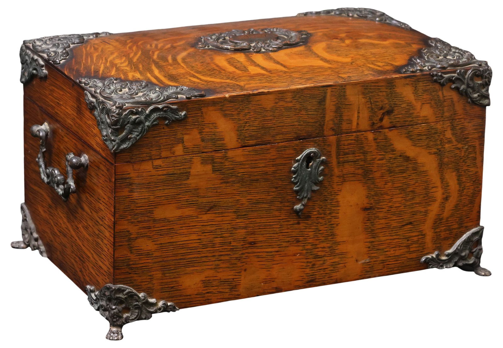 ENGLISH OAK & METAL-LINED CIGAR HUMIDOR: English oak metal-mounted humidor, late 19th/ early 20th c., applied rocaille metal corners, center a monogrammed cartouche, retaining side carry handles, metal escutcheon, interior revealing perforat