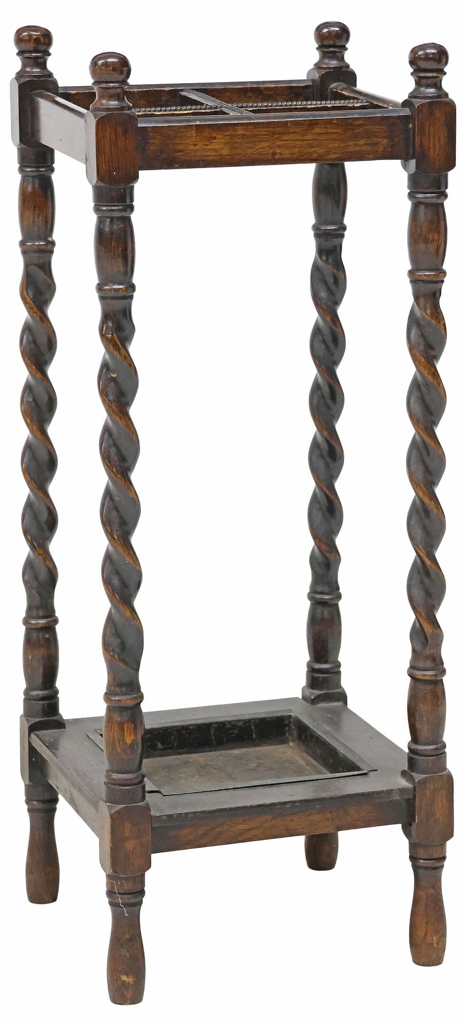 ENGLISH OAK BARLEY TWIST UMBRELLA OR STICK STAND: English oak umbrella or stick stand, early 20th c., having beaded cruciform four-slot top rack, with turned corner finials, rising on barley twist supports, stretcher-joined and fitted with removable