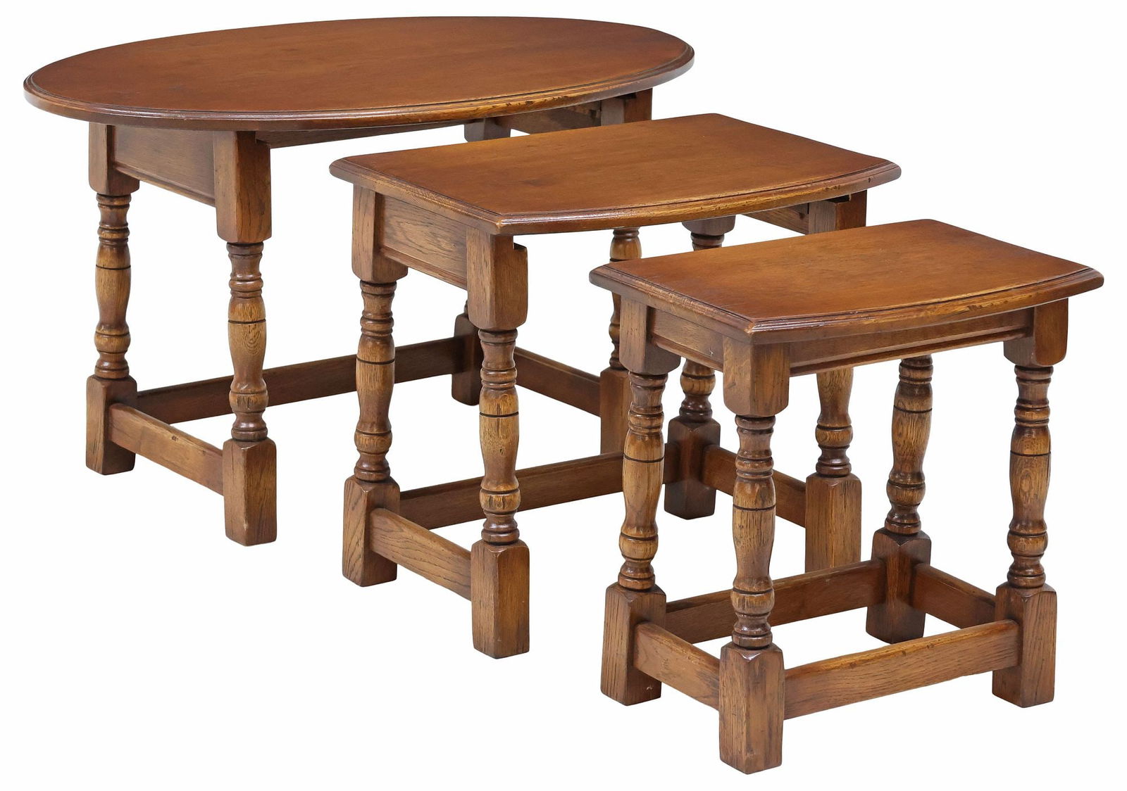 (3) ENGLISH OAK NESTING TABLES: (lot of 3) English oak nesting tables, 20th c., large oval tabletop concealing two additional tabletops of varied shape, rising on stretcher-joined turned legs, largest: approx 18.25"h, 31.5"w, 19.25"