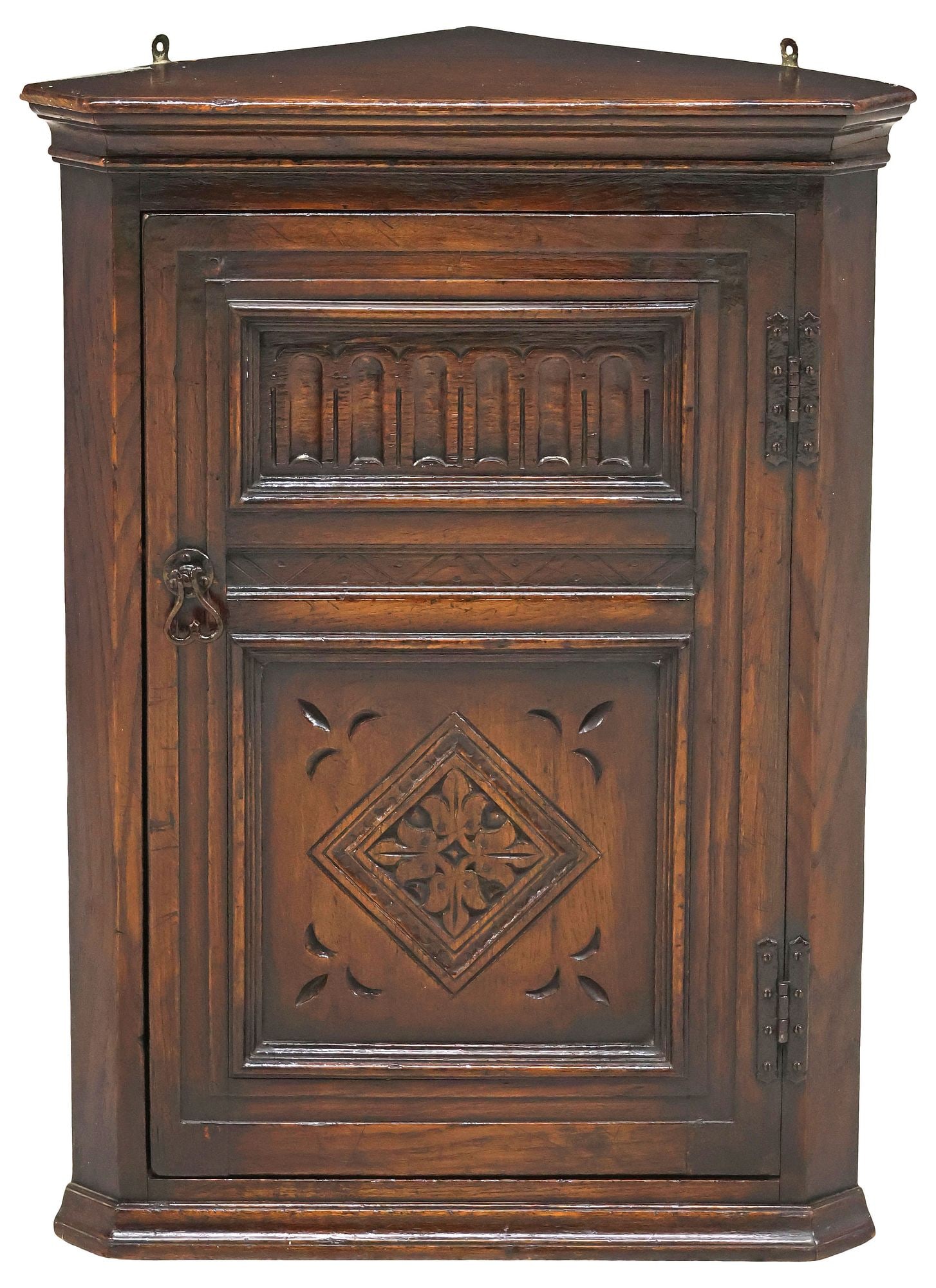 ENGLISH EDWARDIAN CARVED OAK HANGING CORNER CUPBOARD: English Edwardian carved oak hanging corner cupboard, early 20th c., canted case fitted with one cabinet door, opening to fixed shelving, tag to interior "Elliot's of Tunstall," approx 3