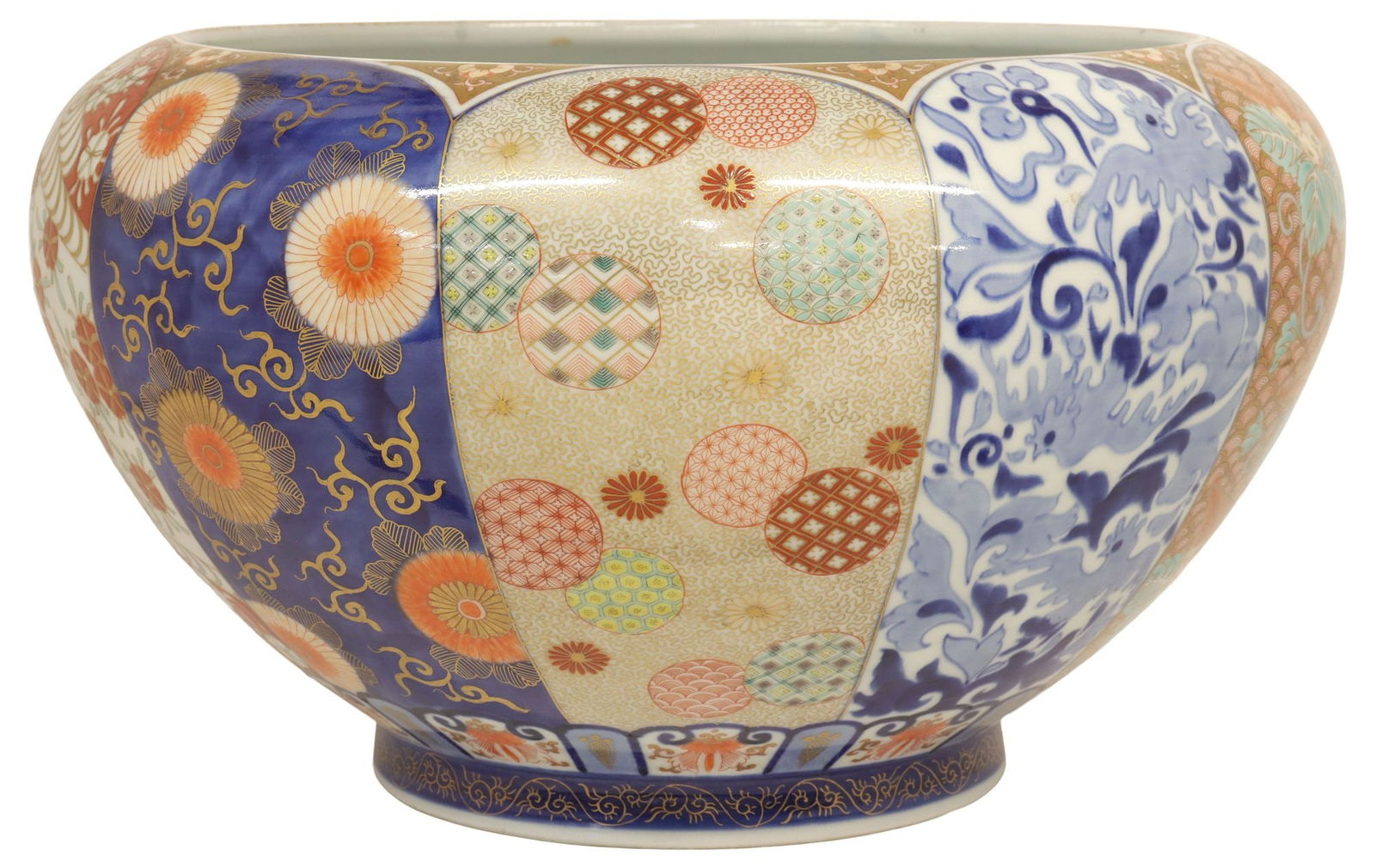 JAPANESE PARCEL-GILT IMARI PALETTE PORCELAIN CENTER BOWL: Japanese Imari-palette porcelain centerpiece bowl, tapered globular basin with parcel-gilt enameled and glazed reserves, framing floral and bird motifs, interior with a carp emerging from water, nine-