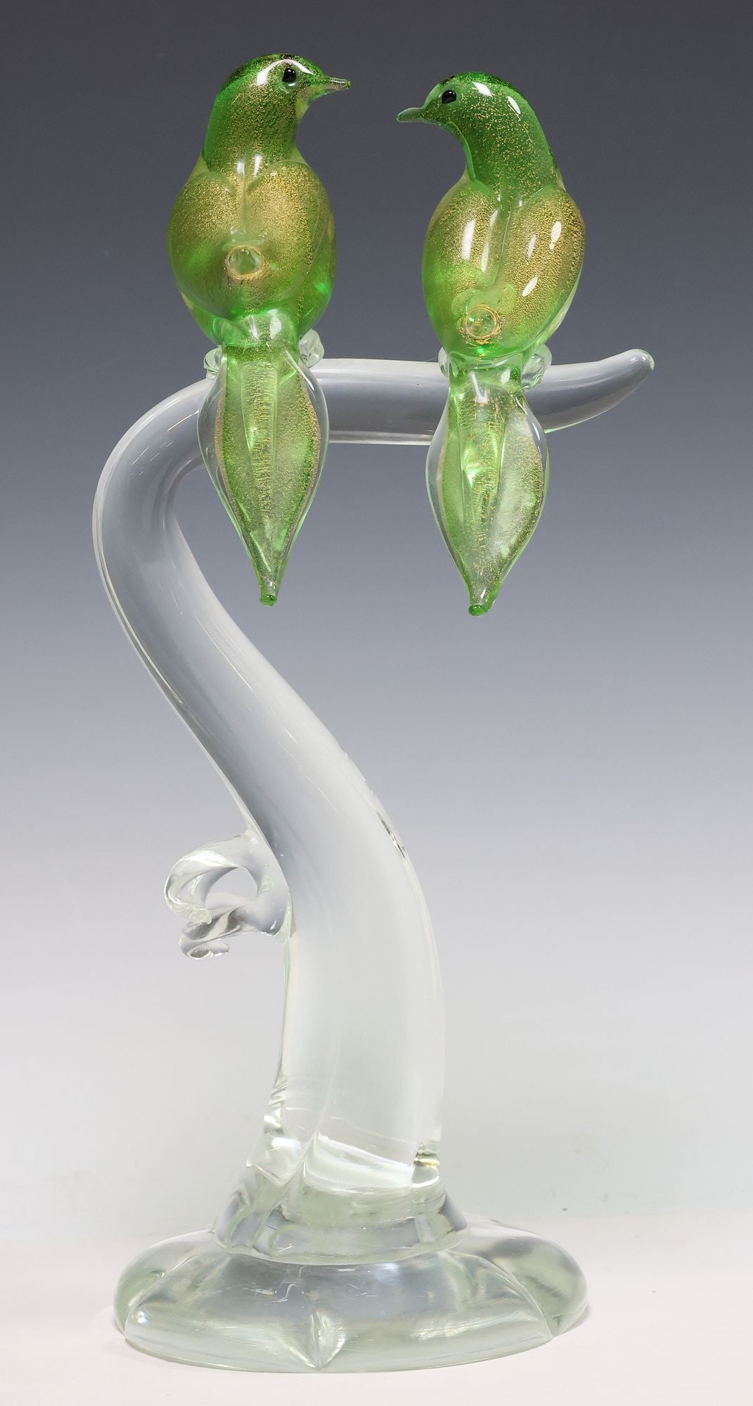 LARGE FORMIA (ATTRIB.) MURANO ART GLASS LOVEBIRDS SCULPTURE, 16"H: Italian Murano art glass sculpture, Lovebirds, attributed to Formia Vetri di Murano, in the form of two inward-facing green birds, with gold aventurine flecks, perched upon a colorless naturalistic br